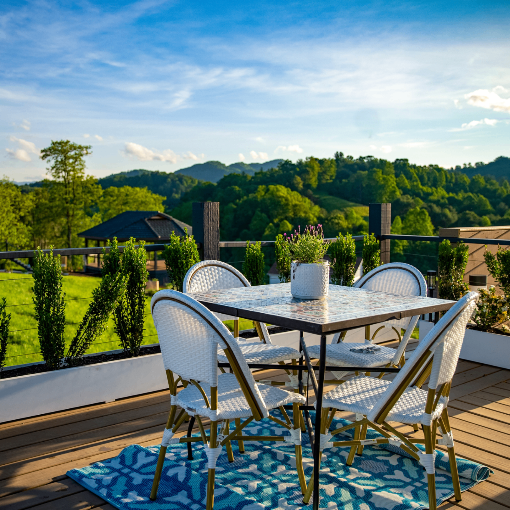 Golden-hour deck with mountain view and bistro dining at Munaya